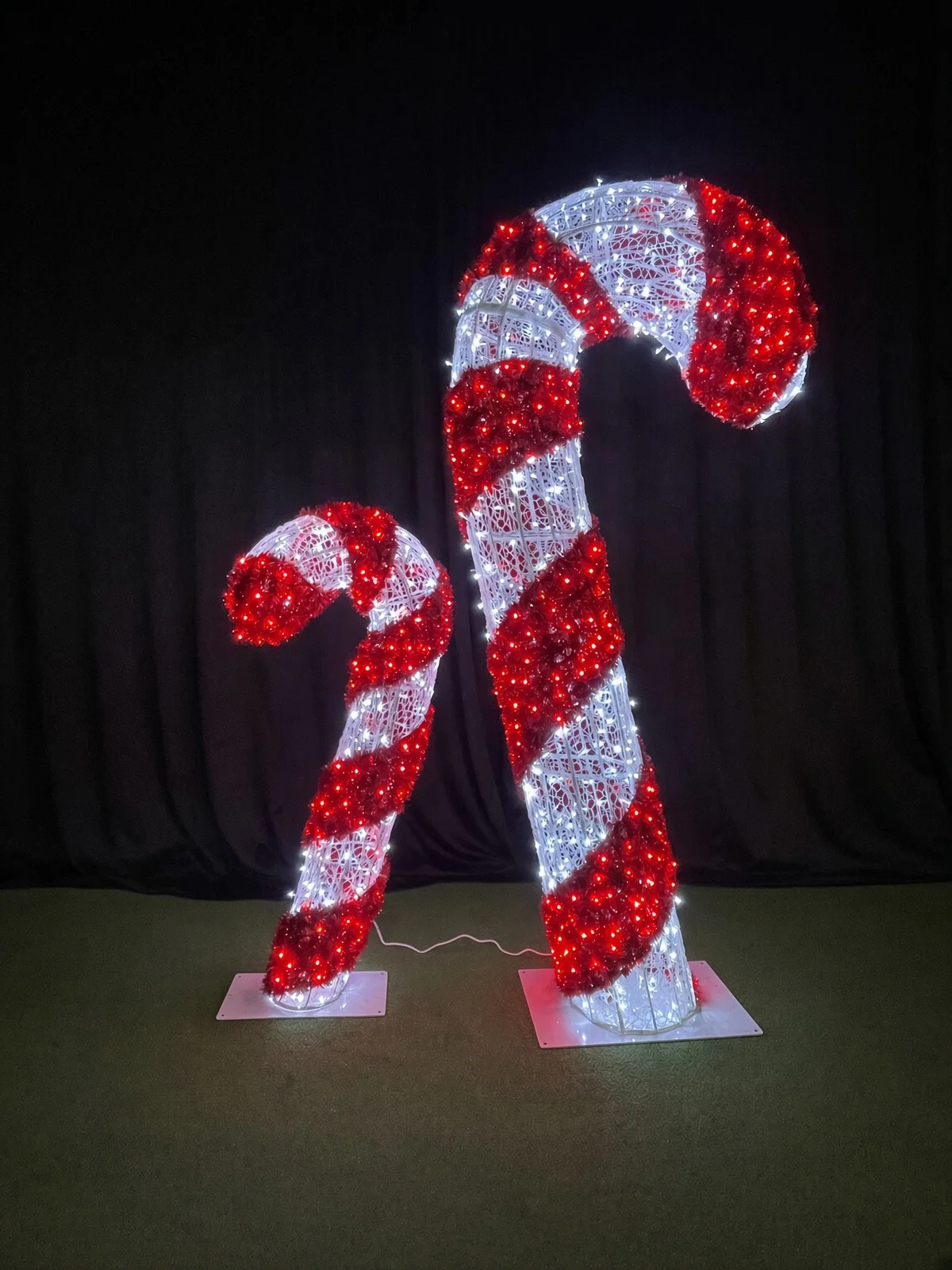 Brighten your holiday display with these giant, outdoor-ready red and white LED tinsel candy cane decorations.