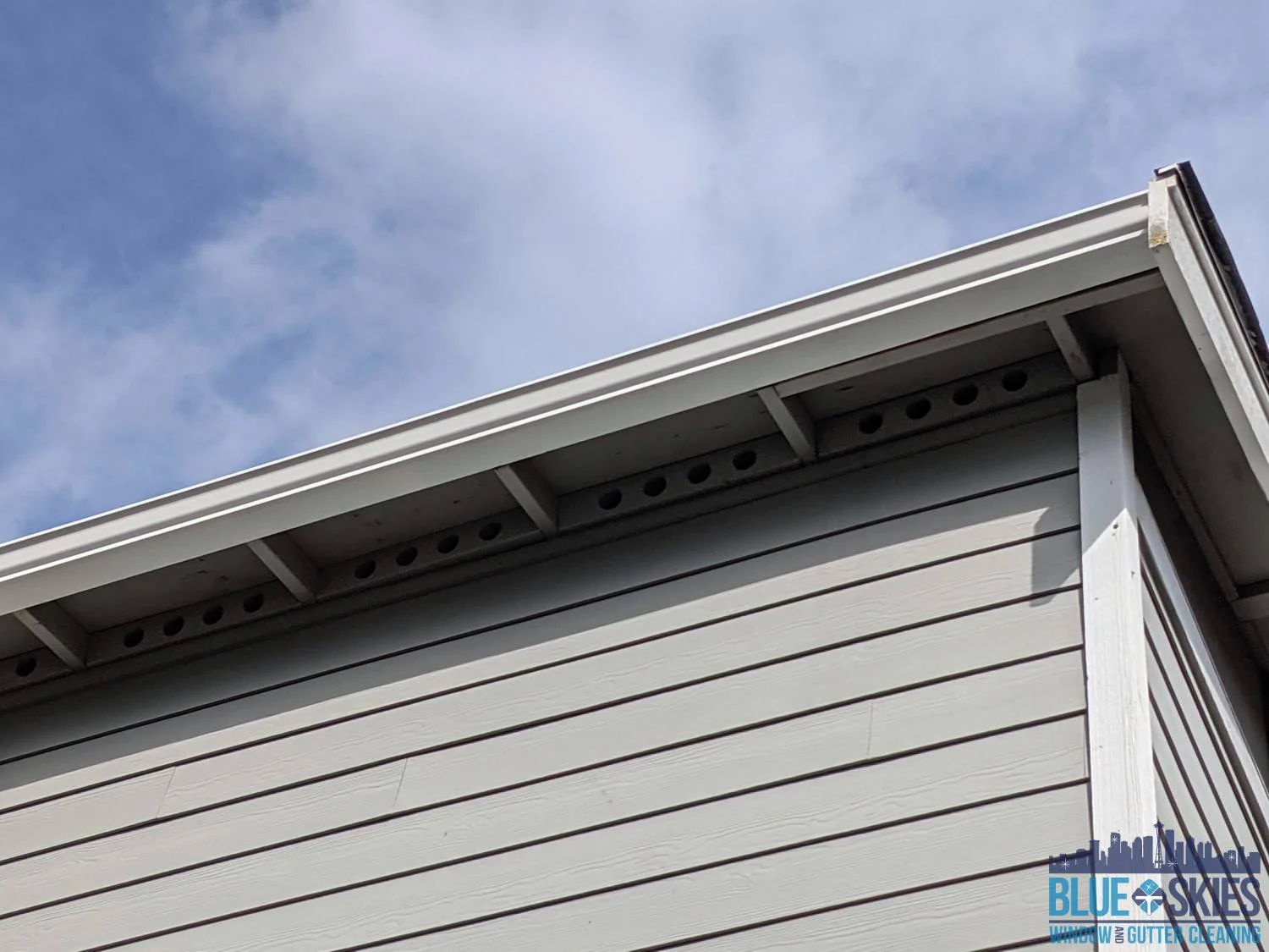 Clean, bright gutters are visible after residential gutter brightening and gutter cleaning services.