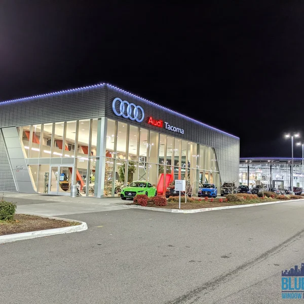Audi Tacoma dealership exterior illuminated with new commercial light installation.