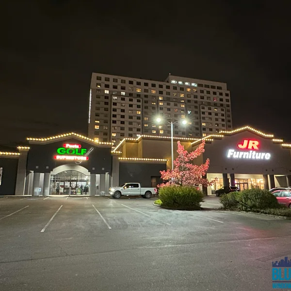Commercial building with festive lights installed by exterior maintenance services at night.