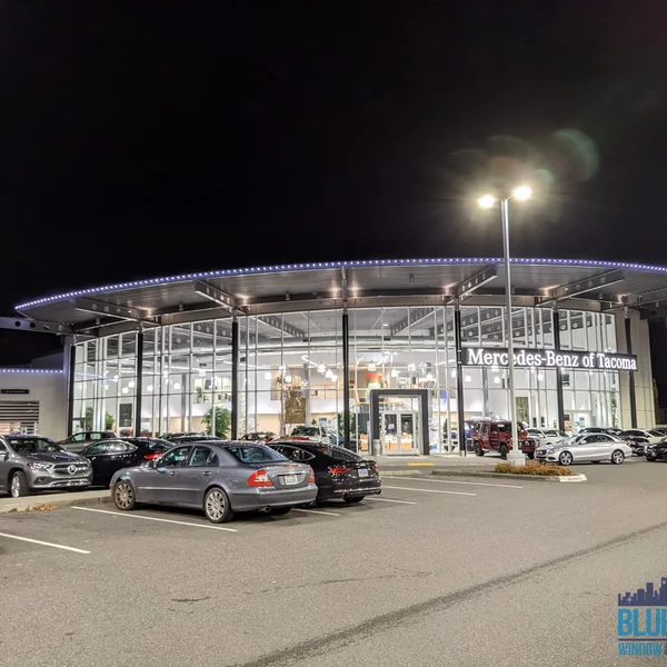 Commercial light installation on the Mercedes-Benz of Tacoma building enhances its nighttime visibility.