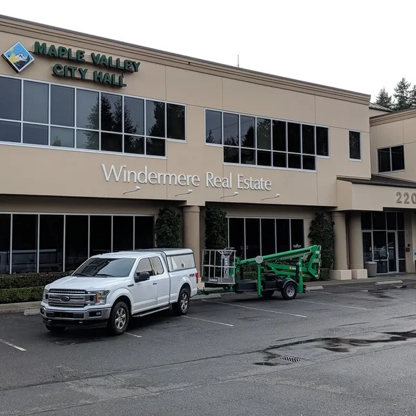 White Ford F-150 with lift in tow is ready for commercial window cleaning at Maple Valley City Hall.