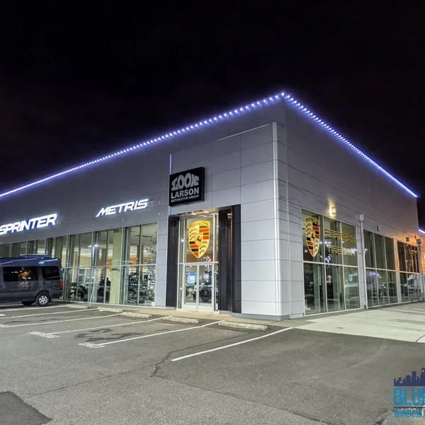 Commercial building exterior illuminated with white lights installed by our exterior maintenance team.