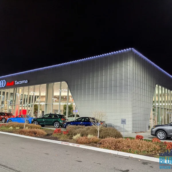 Audi Tacoma dealership exterior at night with newly installed commercial light system.