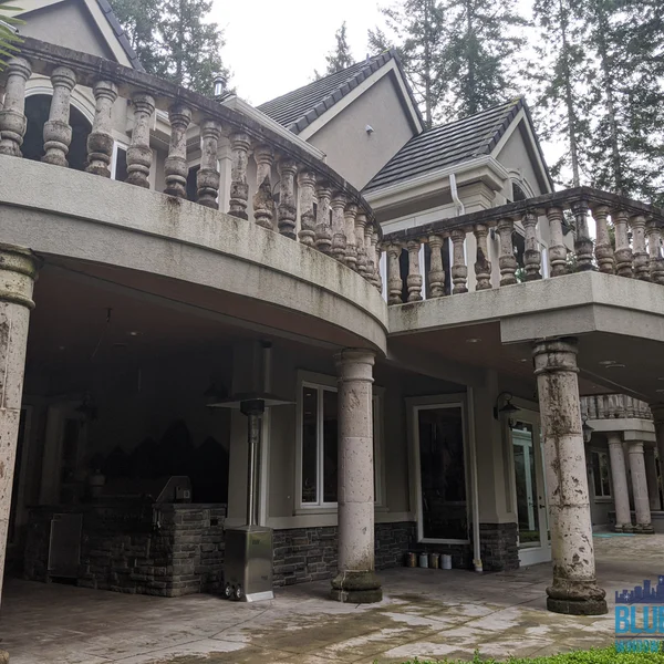Balcony of a home heavily affected by moss and algae needing professional cleaning services.