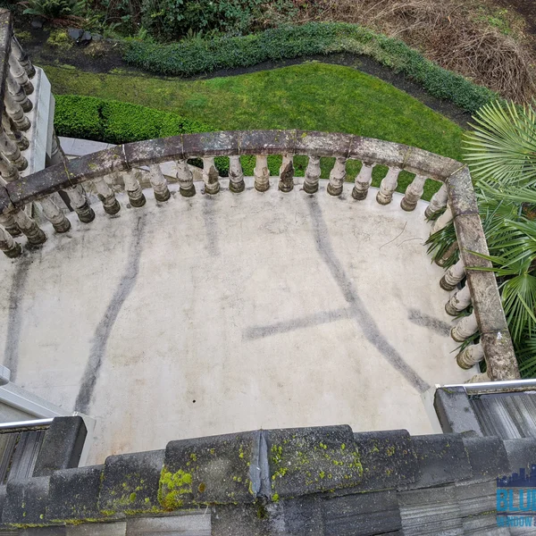 Terrace displays dirt and algae streaks needing residential pressure washing and soft wash roof cleaning services.