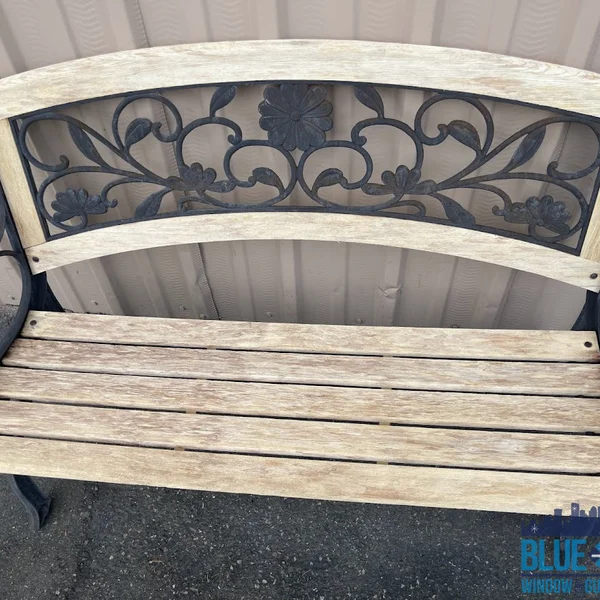 Wooden outdoor bench shows dirt buildup before wood restoration from exterior cleaning service.