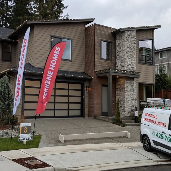 A modern two-story home features clean gutters, roof, and windows after our professional exterior cleaning services.