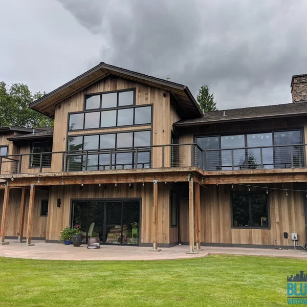 Large wood-sided house with clean gutters after residential algae removal and soft wash roof cleaning.