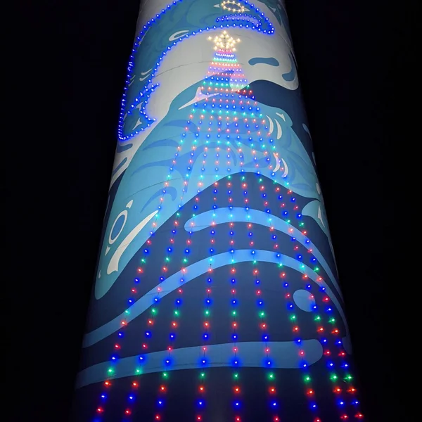 Commercial building with festive Christmas tree lights expertly installed on exterior for the holidays.