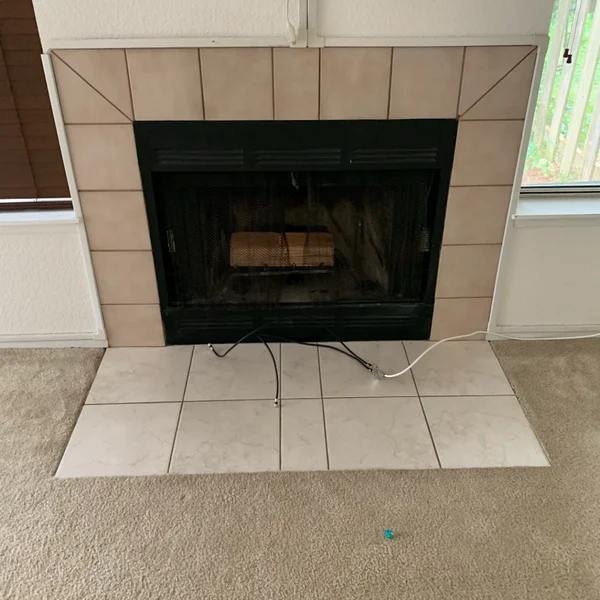 Outdated tile fireplace in need of a home renovation in the greater Seattle area.