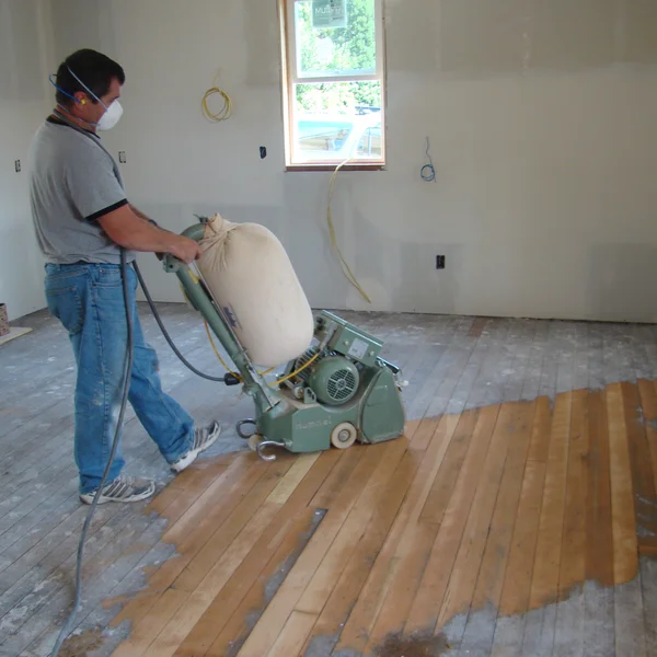 Professional sands original wood flooring for a home renovation in Greater Seattle.