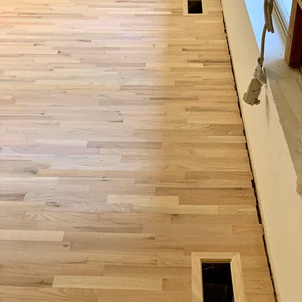 Newly installed light-colored hardwood flooring is showcased in this Seattle home renovation project.