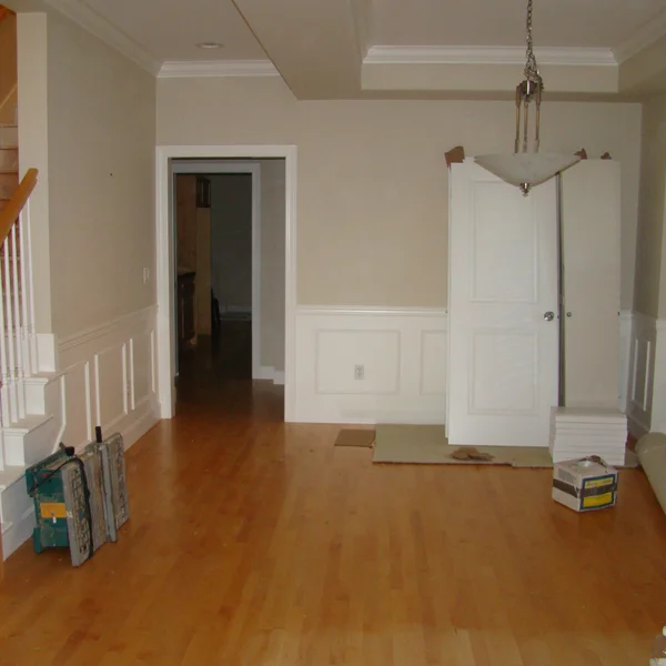 A room renovation in progress with unfinished walls and light wood floors in a Seattle-area home.