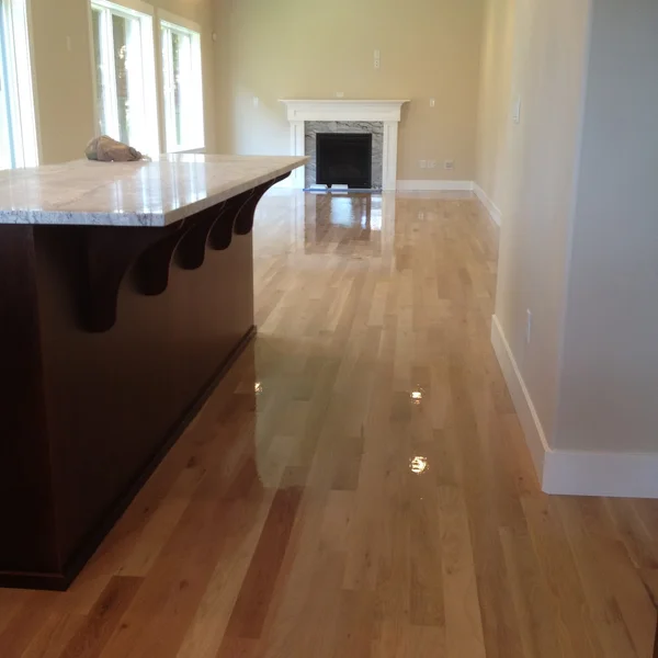 Seattle home renovation project showcasing new hardwood floors, kitchen island, and fireplace.