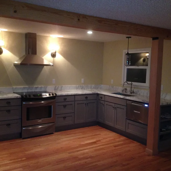 Gray cabinets and marble countertops highlight this Seattle kitchen remodel.