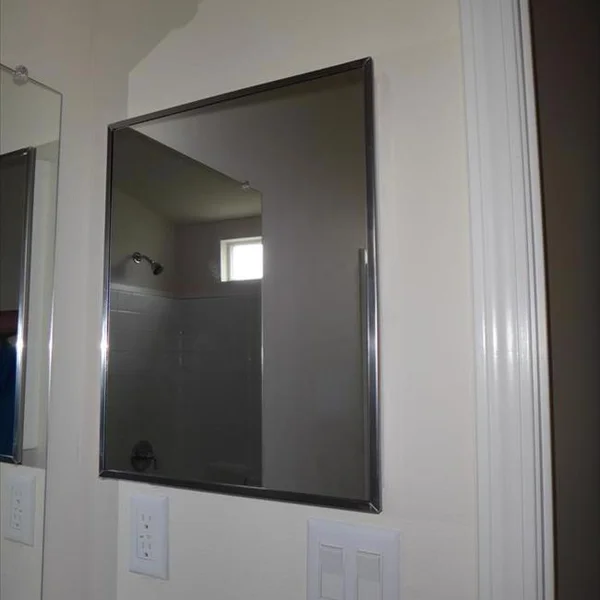 A framed mirror complements the clean design of the bathroom in this manufactured home, part of our park model collection.