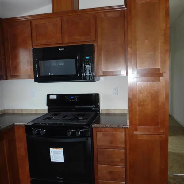 This sleek kitchen design in our Accessory Dwelling Units features Whirlpool appliances and ample storage.