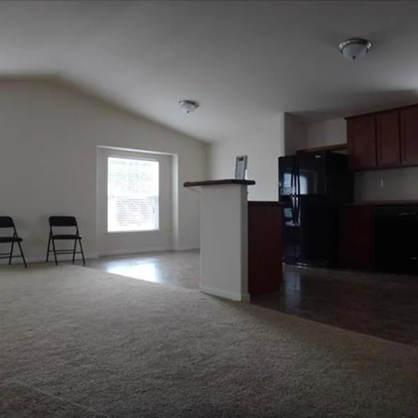 This open floor plan manufactured home features a kitchen island, creating a seamless transition between the cooking and living areas.