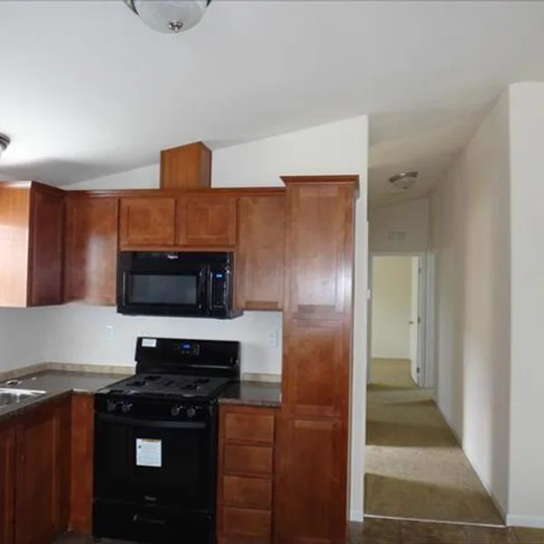 This park model kitchen offers ample storage and modern appliances, perfect for comfortable, convenient living in your new manufactured home.