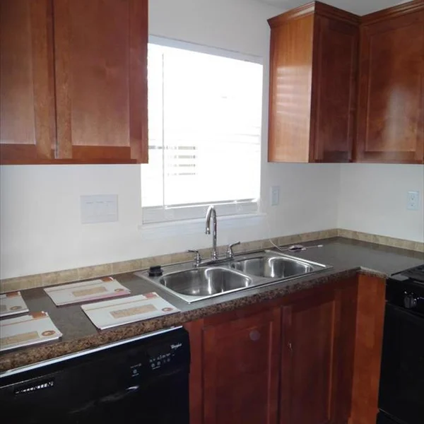 This manufactured home features a compact kitchen with stainless steel appliances and ample cabinet space.